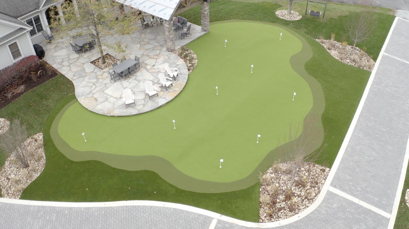 Custom backyard putting green installation with multiple holes